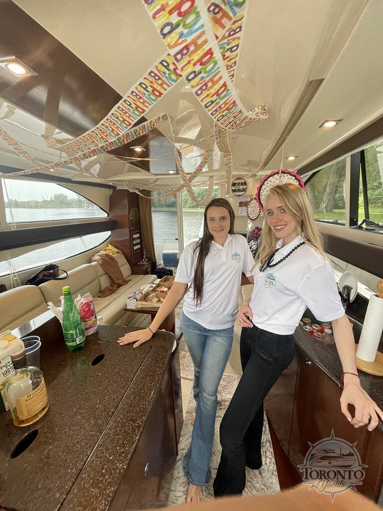 This image captures two stewardesses at Toronto Yachts, participating in a photo opportunity at the boat rental service.